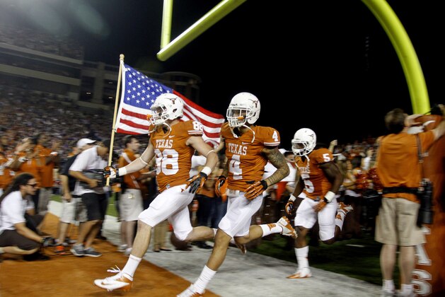 FILE- In this Nov. 22, 2012, file photo, Texas players Kenny Vaccaro (4) and Cedric Reed (88) enter the stadium before the start of an NCAA college football game against TCU in Austin, Texas. Texas has the most valuable college football program in the nation, according to Forbes Magazine. Forbes released its college football evaluations Wednesday, Dec. 19, 2012. The magazine says the Longhorns are worth $133 million, up from $129 million last year. (AP Photo/Jack Plunkett, File) FILE- In this Nov. 22, 2012, file photo, Texas players Kenny Vaccaro (4) and Cedric Reed (88) enter the stadium before the start of an NCAA college football game against TCU in Austin, Texas. Texas has the most valuable college football program in the nation, according to Forbes Magazine. Forbes released its college football evaluations Wednesday, Dec. 19, 2012. The magazine says the Longhorns are worth $133 million, up from $129 million last year. (AP Photo/Jack Plunkett, File)