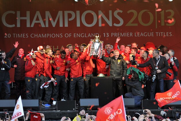 The Manchester United team celebrate with the Premier League trophy, after winning the English Premier League, at Albert Square in Manchester, England, Monday May 13, 2013. (AP Photo/Clint Hughes)