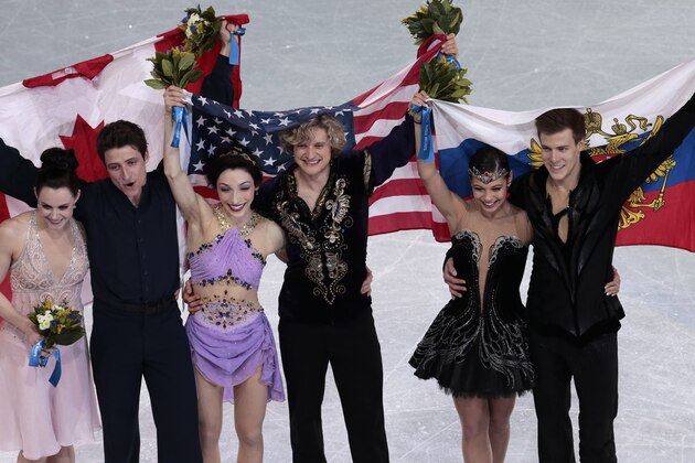 Meryl Davis and Charlie White of the United States, centre, Tessa Virtue and Scott Moir of Canada, left, and Elena Ilinykh and Nikita Katsalapov of Russia pose for photographers following the flower ceremony for the ice dance free dance figure skating finals at the Iceberg Skating Palace during the 2014 Winter Olympics, Monday, Feb. 17, 2014, in Sochi, Russia. Davis and White placed first, Virtue and Moir second, with Ilinykh and Katsalapov third. (AP Photo/Ivan Sekretarev)