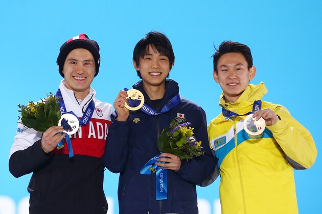 SOCHI, RUSSIA - FEBRUARY 15:  (L-R) Silver medalist Patrick Chan of Canada, gold medalist Yuzuru Hanyu of Japan and bronze medalist Denis Ten of Kazakhstan on the podium during the medal ceremony for the MenÂfs Figure Skating on day 8 of the Sochi 2014 Winter Olympics at Medals Plaza on February 15, 2014 in Sochi, Russia.  (Photo by Streeter Lecka/Getty Images)