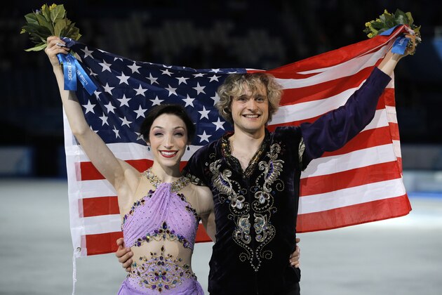 Meryl Davis and Charlie White of the United States pose for photographers after placing first in the ice dance free dance figure skating finals at the Iceberg Skating Palace during the 2014 Winter Olympics, Monday, Feb. 17, 2014, in Sochi, Russia. (AP Photo/Vadim Ghirda)
