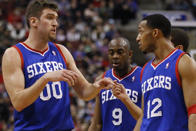 Philadelphia 76ers' Spencer Hawes, left, talks with Evan Turner, left, during the second half of an NBA basketball game, Saturday, Jan. 25, 2014, in Philadelphia. The Thunder won 103-91. (AP Photo/Chris Szagola)