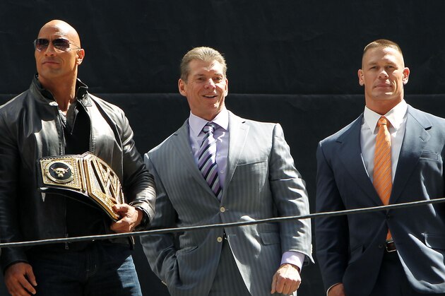 This image released by Starpix shows actor and WWE star Dwayne Johnson, better known as The Rock, left, with Vince McMahon, and WWE star John Cena at a news conference at Radio City Music Hall in New York on Thursday, April 4, 2013. Johnson and Cena will face off in the ring at Wrestlemania 29 on Sunday, April 7, at at MetLife Stadium in East Rutherford, N.J. (AP Photo/Starpix, Dave Allocca) This image released by Starpix shows actor and WWE star Dwayne Johnson, better known as The Rock, left, with Vince McMahon, and WWE star John Cena at a news conference at Radio City Music Hall in New York on Thursday, April 4, 2013. Johnson and Cena will face off in the ring at Wrestlemania 29 on Sunday, April 7, at at MetLife Stadium in East Rutherford, N.J. (AP Photo/Starpix, Dave Allocca)