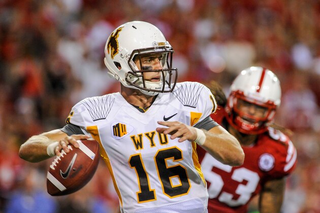 LINCOLN, NE - AUGUST 31: Quarterback Brett Smith #16 of the Wyoming Cowboys scrambles away from defensive tackle Thad Randle #53 of the Nebraska Cornhuskers during their game at Memorial Stadium on August 31, 2013 in Lincoln, Nebraska. Nebraska defeated Wyoming 37-34. (Photo by Eric Francis/Getty Images)