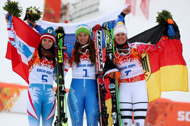 SOCHI, RUSSIA - FEBRUARY 18:  (L-R) Silver medalist Anna Fenninger of Austria, gold medalist Tina Maze of Slovenia and bronze medalist Viktoria Rebensburg of Germany celebrate on the podium during the flower ceremony for the Alpine Skiing Women's Giant Slalom on day 11 of the Sochi 2014 Winter Olympics at Rosa Khutor Alpine Center on February 18, 2014 in Sochi, Russia.  (Photo by Alexander Hassenstein/Getty Images)