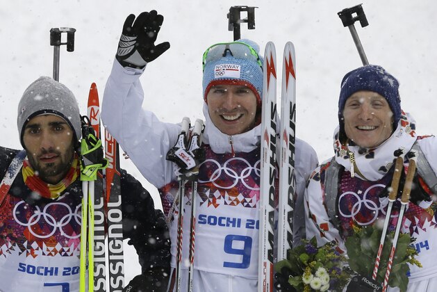 Norway's gold medal winner Emil Hegle Svendsen is flanked by France's silver medal winner Martin Fourcade, left, and Czech Republic's bronze medal winner Ondrej Moravec after the men's biathlon 15k mass-start, at the 2014 Winter Olympics, Tuesday, Feb. 18, 2014, in Krasnaya Polyana, Russia. (AP Photo/Kirsty Wigglesworth)