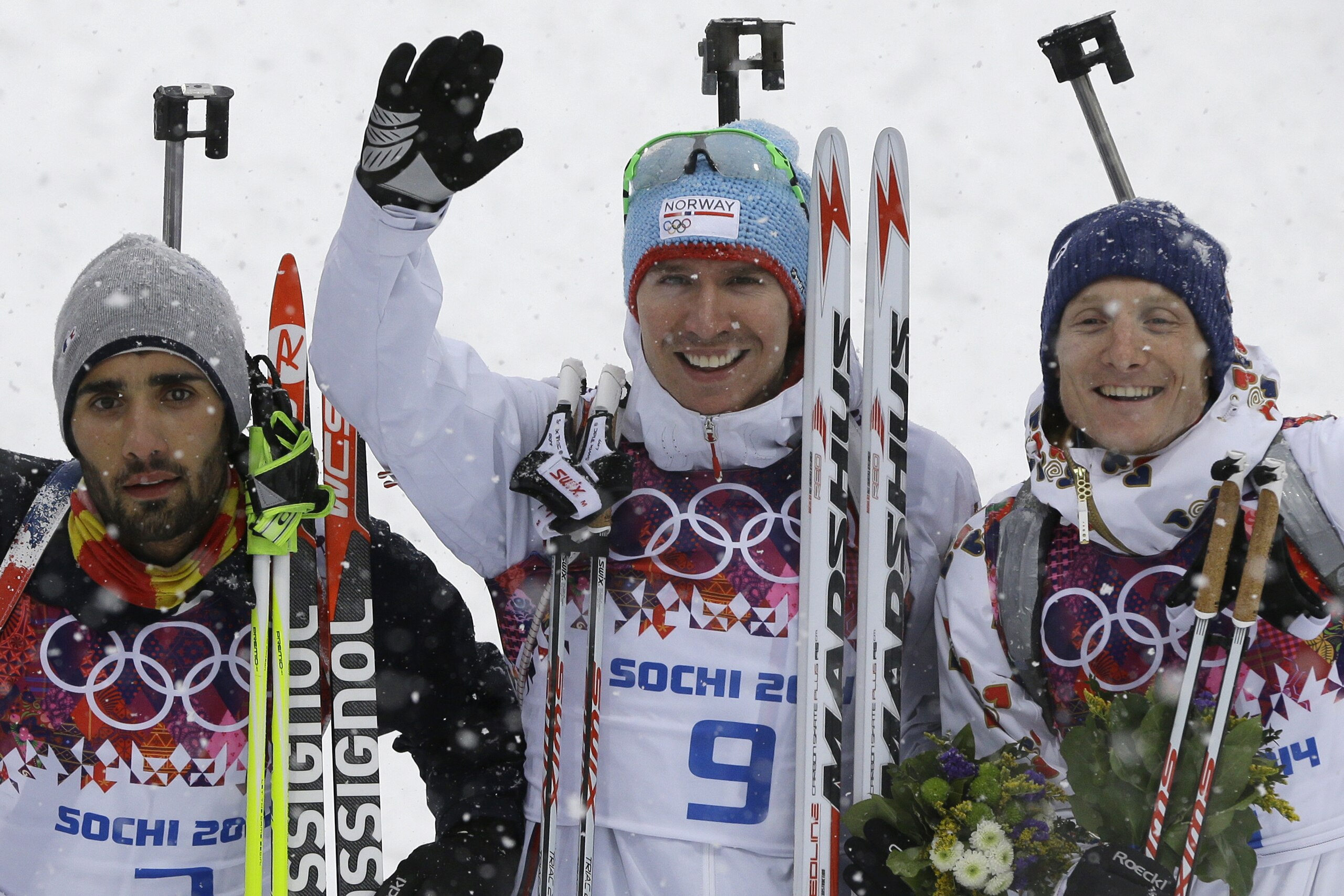 Norway's gold medal winner Emil Hegle Svendsen is flanked by France's silver medal winner Martin Fourcade, left, and Czech Republic's bronze medal winner Ondrej Moravec after the men's biathlon 15k mass-start, at the 2014 Winter Olympics, Tuesday, Feb. 18, 2014, in Krasnaya Polyana, Russia. (AP Photo/Kirsty Wigglesworth)