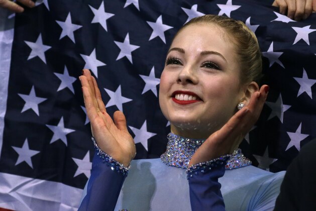 FILE - In a Sunday, Feb. 9, 2014 file photo, Gracie Gold of the United States applauds in the results area after competing in the women's team free skate figure skating competition during the 2014 Winter Olympics, in Sochi, Russia. Some Olympians are turning over their social media accounts to sponsors, agreeing to quotas of postings on Twitter and Facebook and letting other people send commercial messages in their name. The agents for US figure skaters Gold and Ashley Wagner both say sponsors draft some of their tweets, plugging their brands. (AP Photo/Darron Cummings, Pool)