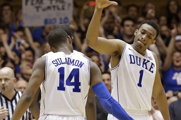 Duke's Jabari Parker (1) and Rasheed Sulaimon (14) react following Parker's basket against Maryland during the second half of an NCAA college basketball game in Durham, N.C., Saturday, Feb. 15, 2014. Duke won 69-67. (AP Photo/Gerry Broome)