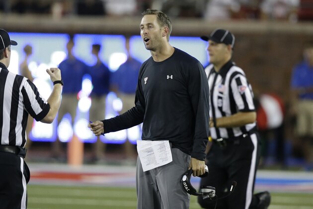 Texas Tech head coach Kliff Kingsbury talks to an official during a NCAA college football game against Southern Methodist Friday, Aug. 30, 2013, in Dallas. Texas Tech won 41-23. (AP Photo/LM Otero)