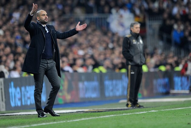 MADRID, SPAIN - JANUARY 18:  Barcelona head coach Josep Guardiola (L) directs his team while Real Madrid head coach Jose Mourinho looks on during the Copa del Rey Quarter Finals match between Real Madrid and Barcelona at Estadio Santiago Bernabeu on January 18, 2012 in Madrid, Spain.  (Photo by Denis Doyle/Getty Images)
