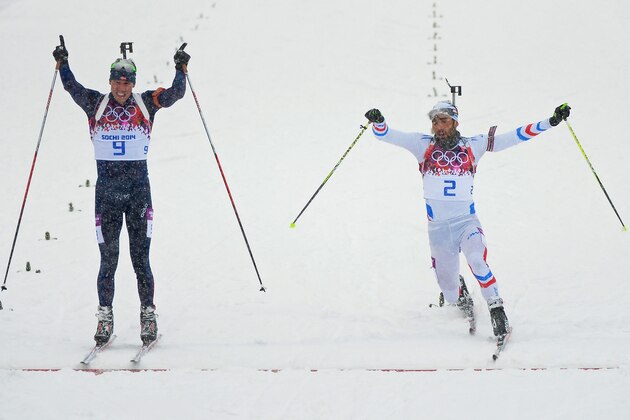 SOCHI, RUSSIA - FEBRUARY 18:  Martin Fourcade of France stretches for the finish line next to Emil Hegle Svendsen of Norway during the Men's 15 km Mass Start during day 11 of the Sochi 2014 Winter Olympics at Laura Cross-country Ski & Biathlon Center on February 18, 2014 in Sochi, Russia.  (Photo by Harry How/Getty Images)