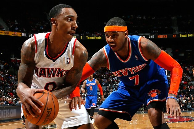 ATLANTA, GA - NOVEMBER 13:  Jeff Teague #0 of the Atlanta Hawks grabs a rebound against Carmelo Anthony #7 of the New York Knicks at Philips Arena on November 13, 2013 in Atlanta, Georgia.  NOTE TO USER: User expressly acknowledges and agrees that, by downloading and or using this photograph, User is consenting to the terms and conditions of the Getty Images License Agreement.  (Photo by Kevin C. Cox/Getty Images)