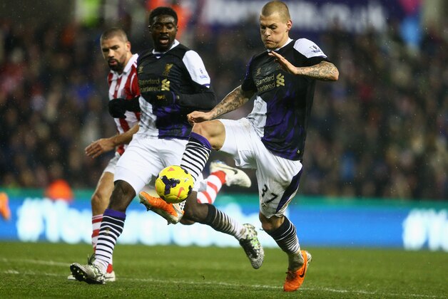 STOKE ON TRENT, ENGLAND - JANUARY 12:  Martin Skrtel of Liverpool is watched by team mate Kolo Toure of Liverpool during the Barclays Premier League match between Stoke City and Liverpool at Britannia Stadium on January 12, 2014 in Stoke on Trent, England.  (Photo by Clive Mason/Getty Images)