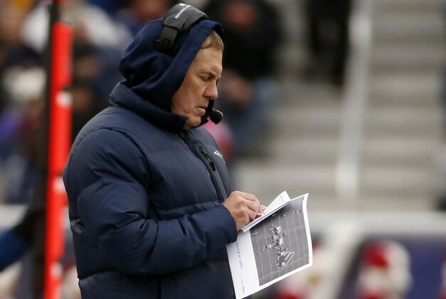 New England Patriots head coach Bill Belichick takes notes on the sideline in the first quarter of an NFL football game against the Cleveland Browns Sunday, Dec. 8, 2013, in Foxborough, Mass. (AP Photo/Elise Amendola)