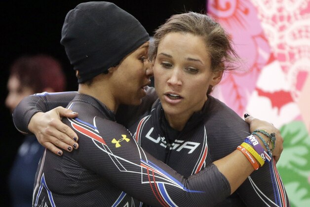 The team from the United States USA-3, pilot Jazmine Fenlator, left, and brakeman Lolo Jones, hug after their second run during the women's two-man bobsled competition at the 2014 Winter Olympics, Tuesday, Feb. 18, 2014, in Krasnaya Polyana, Russia. (AP Photo/Dita Alangkara)