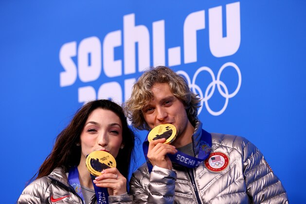 SOCHI, RUSSIA - FEBRUARY 18:  Gold medalists Meryl Davis (L) and Charlie White of the United States celebrate during the medal ceremony for the Figure Skating Ice Danceon day 11 of the Sochi 2014 Winter Olympics at Medals Plaza on February 18, 2014 in Sochi, Russia.  (Photo by Paul Gilham/Getty Images)