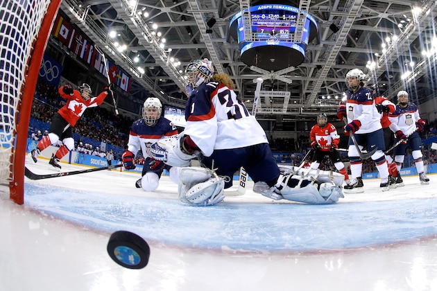 SOCHI, RUSSIA - FEBRUARY 12:  Meghan Agosta-Marciano #2 of Canada celebrates scoring a goal in the third period against Jessie Vetter #31 of the United States during the Women's Ice Hockey Preliminary Round Group A game on day five of the Sochi 2014 Winter Olympics at Shayba Arena on February 12, 2014 in Sochi, Russia.  (Photo by Pool/Getty Images)
