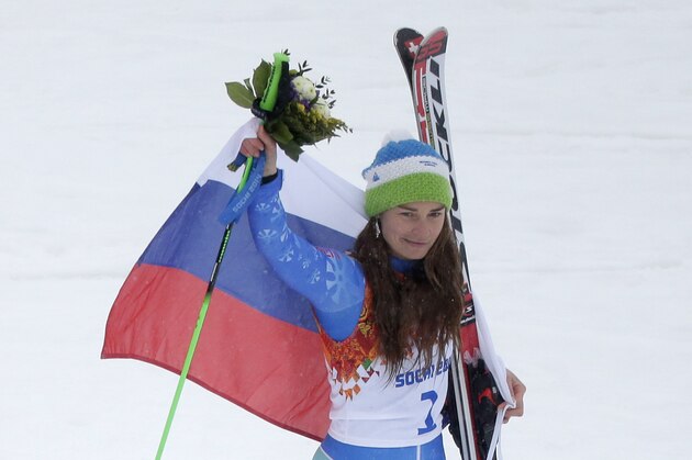 Women's giant slalom gold medalist Slovenia's Tina Maze poses for photographers during the flower ceremony at the Sochi 2014 Winter Olympics, Tuesday, Feb. 18, 2014, in Krasnaya Polyana, Russia. (AP Photo/Charlie Riedel)