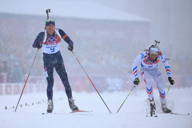 SOCHI, RUSSIA - FEBRUARY 18:  Emil Hegle Svendsen of Norway (L) races to the line to win gold ahead of Martin Fourcade of France in the Men's 15 km Mass Start during day 11 of the Sochi 2014 Winter Olympics at Laura Cross-country Ski & Biathlon Center on February 18, 2014 in Sochi, Russia.  (Photo by Richard Heathcote/Getty Images)
