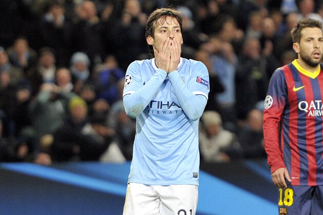 Manchester City's David Silva, left, reacts after he sees his shot on goal saved, during their Champions League Round of 16 soccer match against Barcelona at the Etihad Stadium in Manchester, England, Tuesday, Feb. 18, 2014. (AP Photo/Clint Hughes)