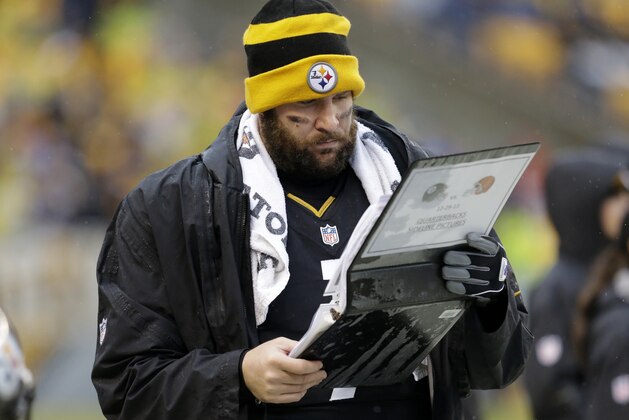 Pittsburgh Steelers quarterback Ben Roethlisberger (7) studies a book of photos  on the sidelines during the second half of an NFL football game against the Cleveland Browns in Pittsburgh, Sunday, Dec. 29, 2013. The Steelers won 20-7. (AP Photo/Gene J. Puskar)