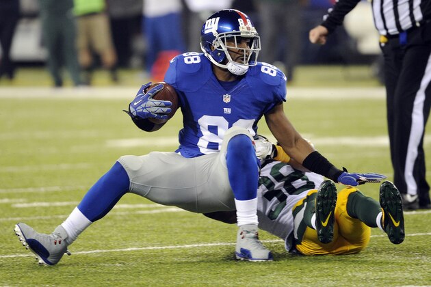 New York Giants' Hakeem Nicks (88) is tackled by Green Bay Packers' Tramon Williams (38) during the first half of an NFL football game Sunday, Nov. 17, 2013, in East Rutherford, N.J. (AP Photo/Bill Kostroun)