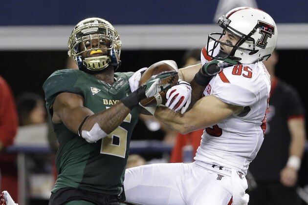 Texas Tech wide receiver Jordan Davis (85) catches a pass against Baylor safety Ahmad Dixon (6) during the first half of an NCAA college football game in Arlington, Texas, Saturday, Nov. 16, 2013. (AP Photo/LM Otero)