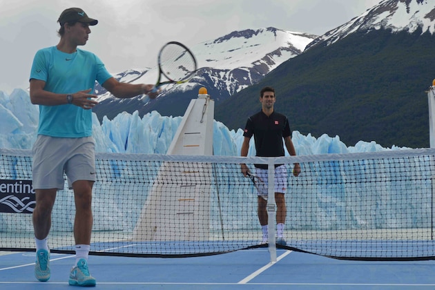 In this picture released by Argentina's Ministry of Tourism, tennis players Rafael Nadal, left, and Novak Djokovic  pose in front of Glacier Perito Moreno from a tennis court on a ship where they played an exhibition game near El Calafate, Argentina, Friday, Nov. 22, 2013. (AP Photo, Argentina's Ministry of Tourism)