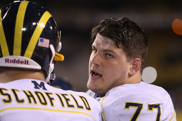 TEMPE, AZ - DECEMBER 28:  Offensive linesman Taylor Lewan #77 of the Michigan Wolverines on the sidelines during the Buffalo Wild Wings Bowl against the Kansas State Wildcats at Sun Devil Stadium on December 28, 2013 in Tempe, Arizona. The Wildcats defeated the Wolverines 31-14.  (Photo by Christian Petersen/Getty Images)