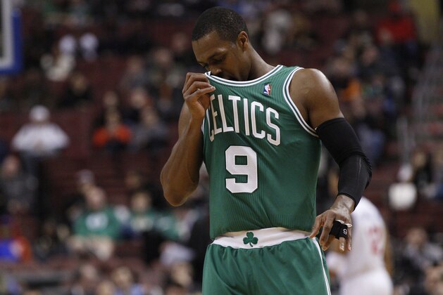 Boston Celtics' Rajon Rondo wipes his jersey on his face during the first half of an NBA basketball game against the Philadelphia 76ers, Wednesday, Feb. 5, 2014, in Philadelphia. The Celtics won 114-108. (AP Photo/Chris Szagola)