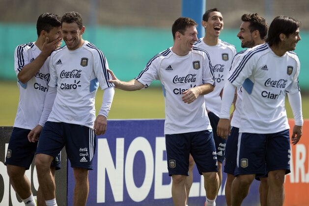 Argentina's Sergio Aguero, from left, Maximiliano Rodriguez, Lionel Messi, Angel Di Maria, Ezequiel Lavezzi and Ever Banega leave the field after a training session ahead of their 2014 World Cup qualifying soccer match against Paraguay, in Buenos Aires, Argentina, Friday, Sept. 6, 2013. (AP Photo/Natacha Pisarenko)