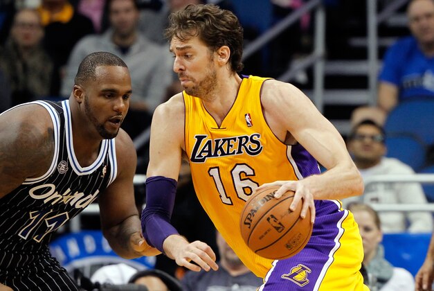 Jan 24, 2014; Orlando, FL, USA; Los Angeles Lakers center Pau Gasol (16) drives to the basket as Orlando Magic power forward Glen Davis (11) defends during the second half at Amway Center. Orlando Magic defeated the Los Angeles Lakers 114-105. Mandatory Credit: Kim Klement-USA TODAY Sports