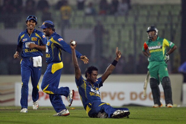 Sri Lanka’s Angelo Mathews, on the ground, celebrates with teammates their win over Bangladesh during their first one day international cricket match in Dhaka, Bangladesh, Monday, Feb. 17, 2014. Sri Lanka won by 13 runs. (AP Photo/A.M. Ahad)