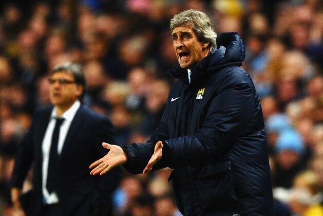 MANCHESTER, ENGLAND - FEBRUARY 18:  Manchester City Manager Manuel Pellegrini reacts during the UEFA Champions League Round of 16 first leg match between Manchester City and Barcelona at the Etihad Stadium on February 18, 2014 in Manchester, England.  (Photo by Laurence Griffiths/Getty Images)