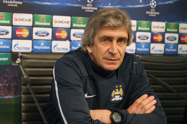 MANCHESTER, ENGLAND - FEBRUARY 17:  Manchester City manager Manuel Pellegrini and midfielder Yaya Toure listen to questions from the media during a press conference after a training session ahead of their UEFA Champions League Round of 16 match 1st leg against Barcelona  at Etihad Stadium on February 17, 2014 in Manchester, England.  (Photo by Clive Brunskill/Getty Images)