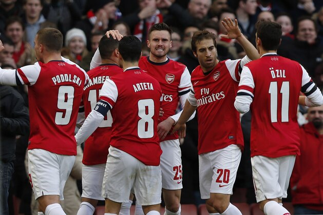 Arsenal's Alex Oxlade-Chamberlain, second left, celebrates his goal against Liverpool with teammates during their English FA Cup fifth round soccer match at Emirates Stadium in London, Sunday, Feb. 16, 2014. (AP Photo/Sang Tan)