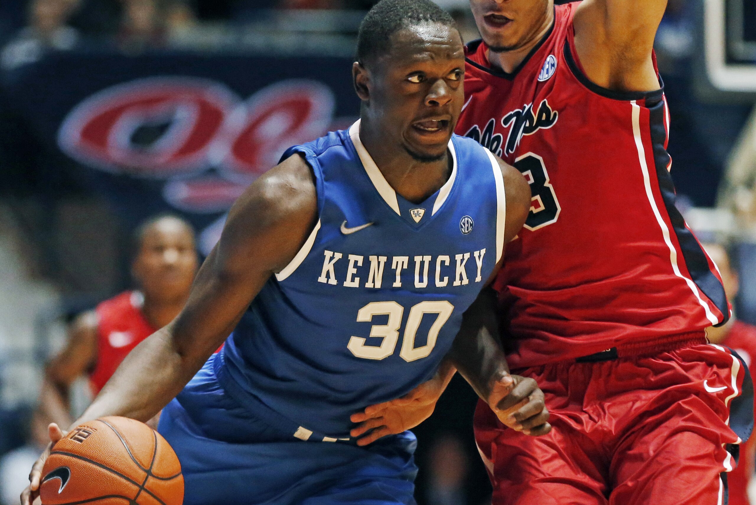 Kentucky forward Julius Randle (30) dribbles up court against Mississippi forward Anthony Perez (13) during the second half of an NCAA college basketball game in Oxford, Miss., Tuesday, Feb. 18, 2014. Kentucky won 84-70. (AP Photo/Rogelio V. Solis)