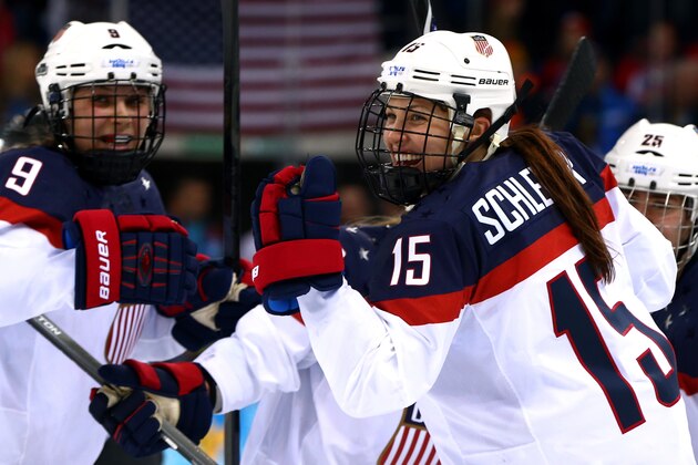 SOCHI, RUSSIA - FEBRUARY 12: Anne Schleper #15 of the United States celebrates with teammate Megan Bozek #9 after setting up Hilary Knight #21 (Not Pictured)to score a goal against Canada during the Women's Ice Hockey Preliminary Round Group A game on day five of the Sochi 2014 Winter Olympics at Shayba Arena on February 12, 2014 in Sochi, Russia.  (Photo by Paul Gilham/Getty Images)
