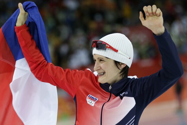 Martina Sablikova of the Czech Republic holds her national flag and celebrates after winning gold in the women's 5,000-meter speedskating race at the Adler Arena Skating Center during the 2014 Winter Olympics in Sochi, Russia, Wednesday, Feb. 19, 2014. (AP Photo/Matt Dunham)