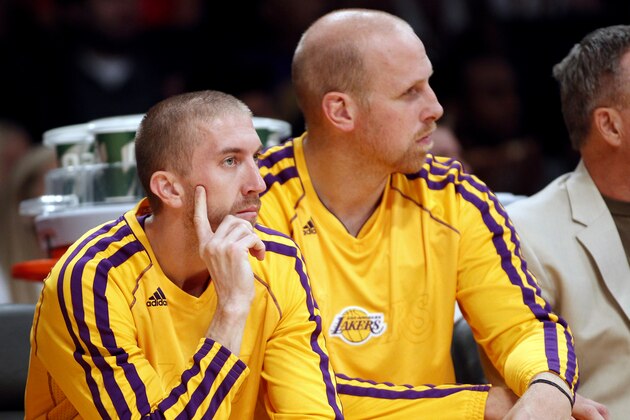 Los Angeles Lakers guard Steve Blake, left, waits on the bench with Lakers center Chris Kaman playing against the Denver Nuggets during an NBA preseason basketball game Sunday, Oct. 6, 2013 in Los Angeles.  (AP Photo/Alex Gallardo)