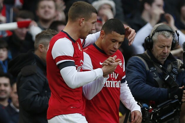 Arsenal's Alex Oxlade-Chamberlain, right, celebrates his goal against Liverpool with teammate Lukas Podolski during their English FA Cup fifth round soccer match at Emirates Stadium in London, Sunday, Feb. 16, 2014. (AP Photo/Sang Tan)