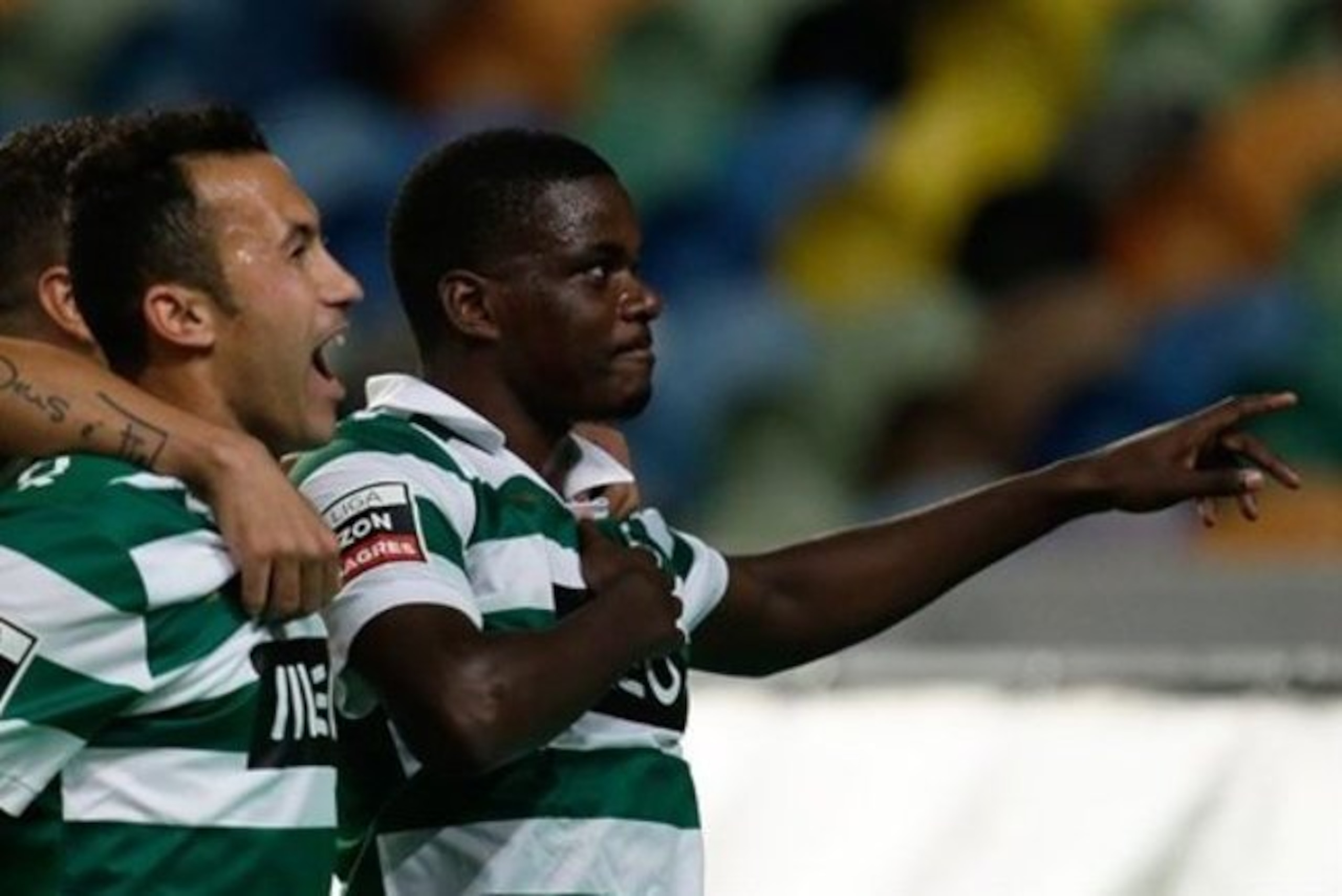 Sporting's William Carvalho, right, celebrates after scoring the opening goal against Pacos de Ferreira during their Portuguese league soccer match Sunday, Dec. 1, 2013, at Sporting's Alvalade stadium in Lisbon. (AP Photo/Armando Franca)