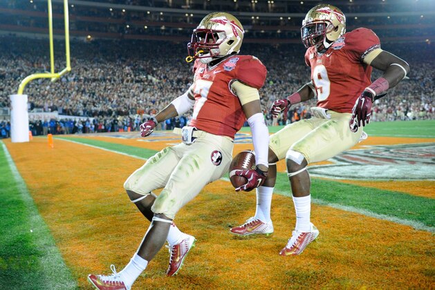 Jan 6, 2014; Pasadena, CA, USA; Florida State Seminoles receiver Levonte Whitfield (7) celebrates with running back Karlos Williams (9) after scoring on a 100-yard kickoff return against the Auburn Tigers in the fourth quarter of the 2014 BCS National Championship game at the Rose Bowl.  Mandatory Credit: Kirby Lee-USA TODAY Sports