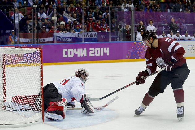 Latvia forward Lauris Darzins flips the puck past Canada goaltender Carey Price for a goal during the first period of a men's quarterfinal ice hockey game at the 2014 Winter Olympics, Wednesday, Feb. 19, 2014, in Sochi, Russia. (AP Photo/Julio Cortez) Latvia forward Lauris Darzins flips the puck past Canada goaltender Carey Price for a goal during the first period of a men's quarterfinal ice hockey game at the 2014 Winter Olympics, Wednesday, Feb. 19, 2014, in Sochi, Russia. (AP Photo/Julio Cortez)