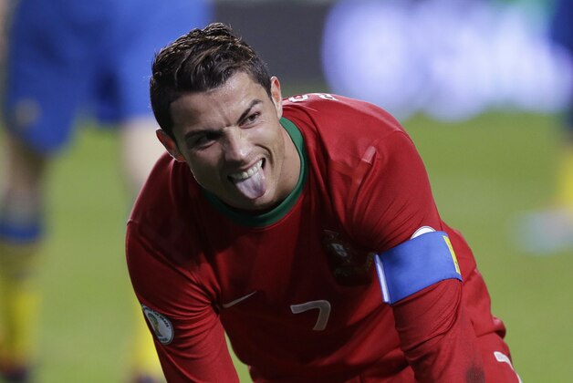 Portugal's Cristiano Ronaldo sticks his tongue out after a fall during the World Cup qualifying playoff first leg soccer match between Portugal and Sweden Friday, Nov. 15 2013, at the Luz stadium in Lisbon. (AP Photo/Armando Franca)