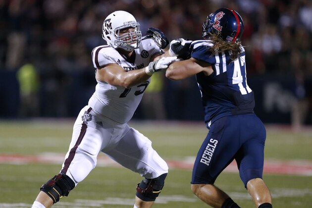 Texas A&M offensive linesman Jake Matthews (75) blocks off Mississippi defensive end John Youngblood (47) in the second half of their NCAA college football game at Vaught-Hemingway Stadium in Oxford, Miss., Saturday, Oct. 12, 2013. No. 9 Texas A&M won 41-38. (AP Photo/Rogelio V. Solis)