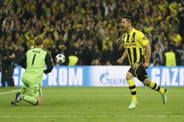 Dortmund's Ilkay Guendogan, right, celebrates scoring his side's first goal, during the Champions League Final between  Borussia Dortmund and Bayern Munich at Wembley Stadium in London, Saturday May 25, 2013. (AP Photo/Kirsty Wigglesworth)