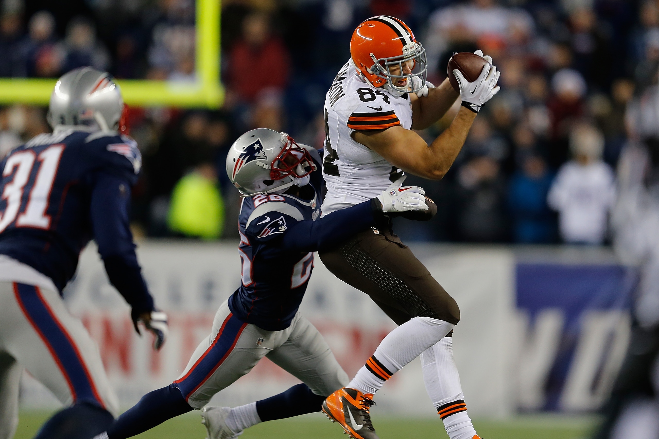 FOXBORO, MA - DECEMBER 8:  Jordan Cameron #84 of the Cleveland Browns catches a pass as Steve Gregory #28 of the New England Patriots defends at Gillette Stadium on December 8, 2013 in Foxboro, Massachusetts. (Photo by Jim Rogash/Getty Images)