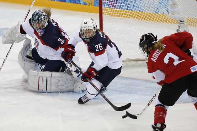 Meghan Agosta-Marciano of Canada shoots the puck past Kendall Coyne (26) and USA Goalkeeper Jessie Vetter for a goal during the third period of the 2014 Winter Olympics women's ice hockey game at Shayba Arena, Wednesday, Feb. 12, 2014, in Sochi, Russia. (AP Photo/Petr David Josek)